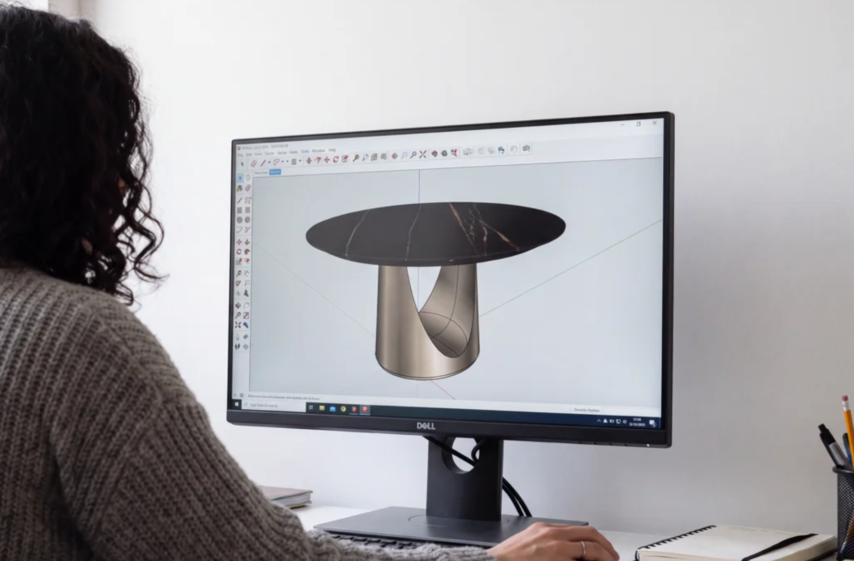 Designer reviewing a 3D SketchUp model of a custom dining table